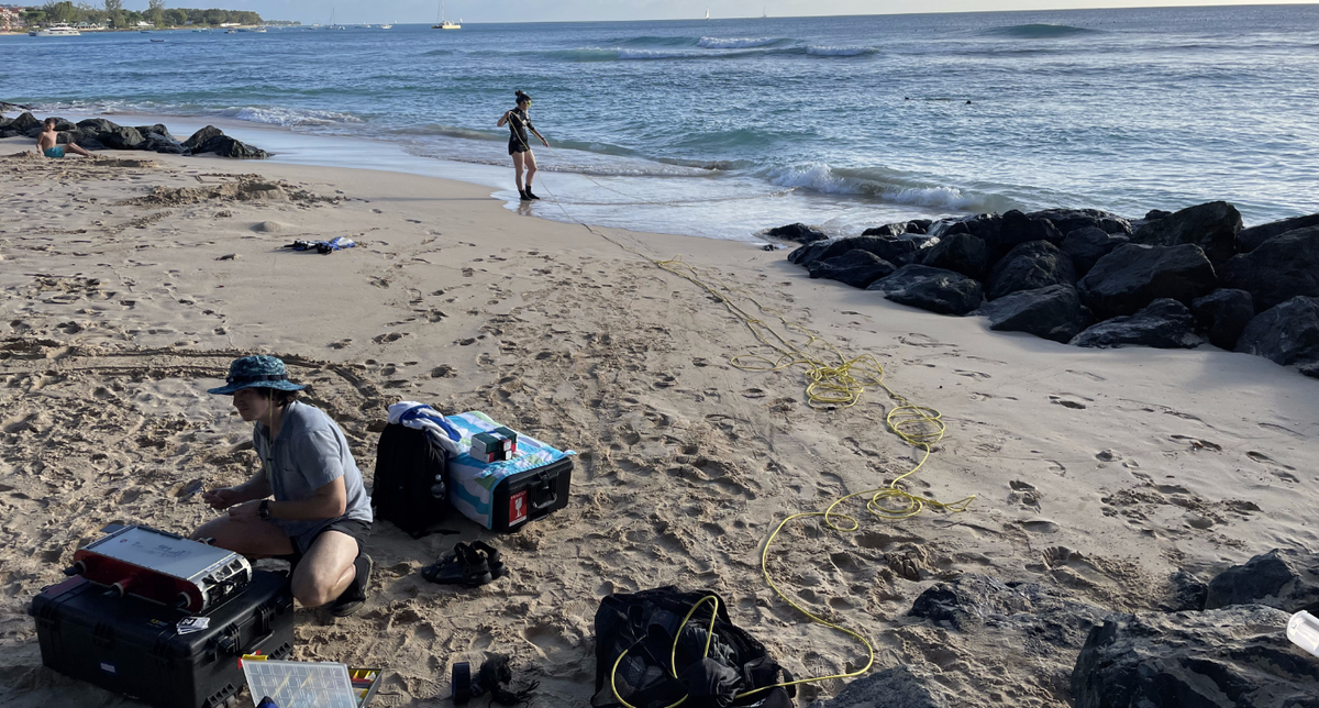 Two from Satter's team sets up the robot on the side of the beach