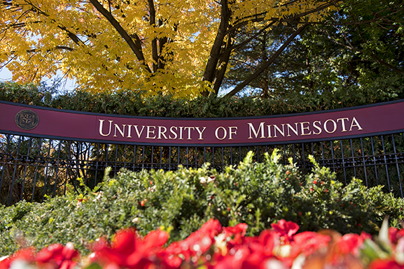 A sign displaying "University of Minnesota" in gold lettering against a maroon background.