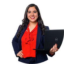 A woman in a business suit holding a laptop