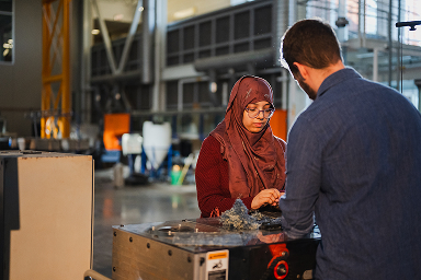 Two students working together in the High Bay Lab